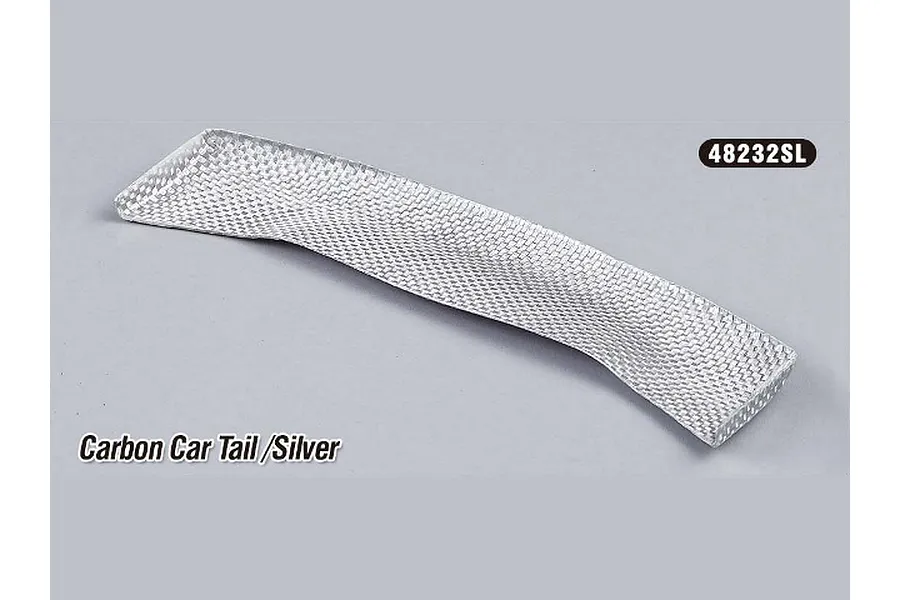 A silver carbon fibre style RC touring car rear wing or tail piece on a plain grey background.