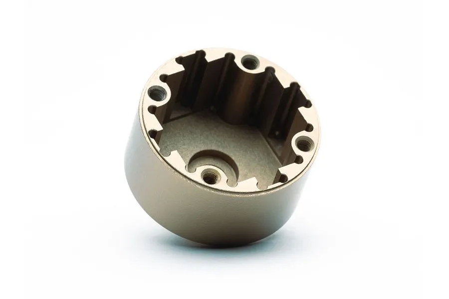 A gold-coloured aluminium differential case for an RC car, shown from an angled top-down perspective against a white background.