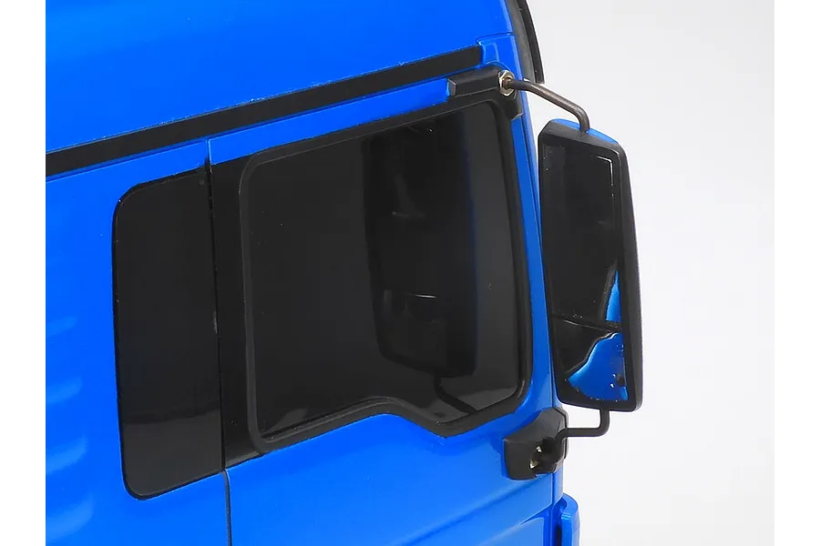 Close-up of the side mirror and window area on a metallic blue Tamiya MAN TGX RC truck model.