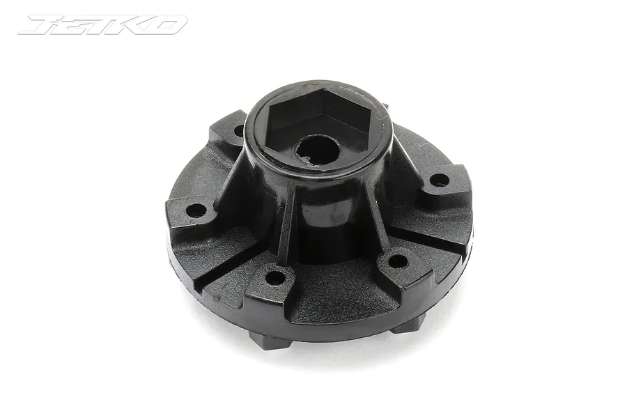 A black plastic 12mm hex wheel connector for 1/10 scale RC vehicles, featuring a central hex hub and mounting points.