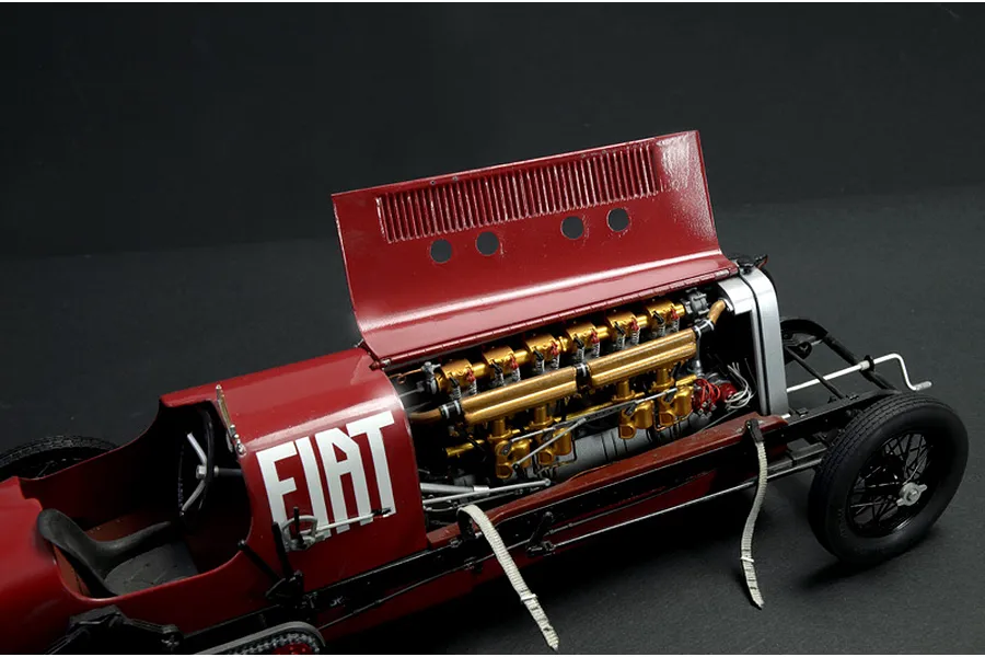 A detailed 1/12 scale model of the Fiat Mephistofele race car with its hood open, revealing the intricate gold-painted engine and red bodywork.