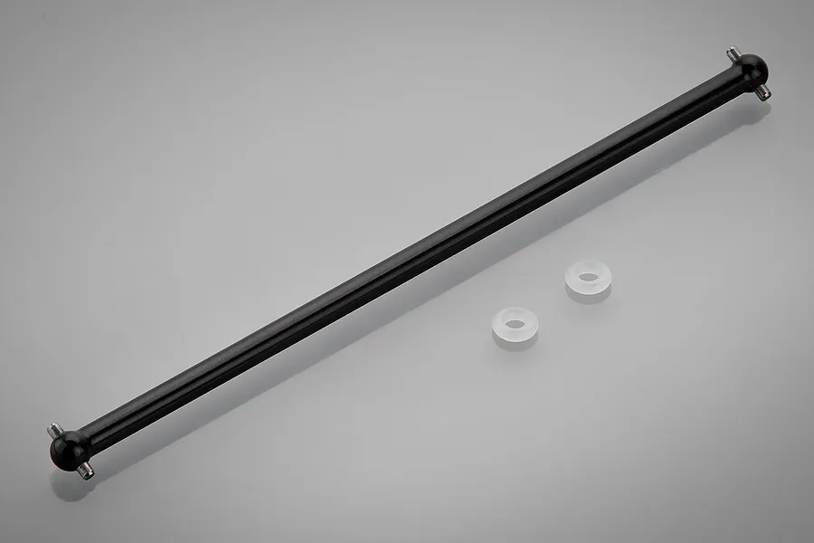 A black metal RC centre drive shaft with ball joints at both ends, accompanied by two small white plastic washers on a grey background.