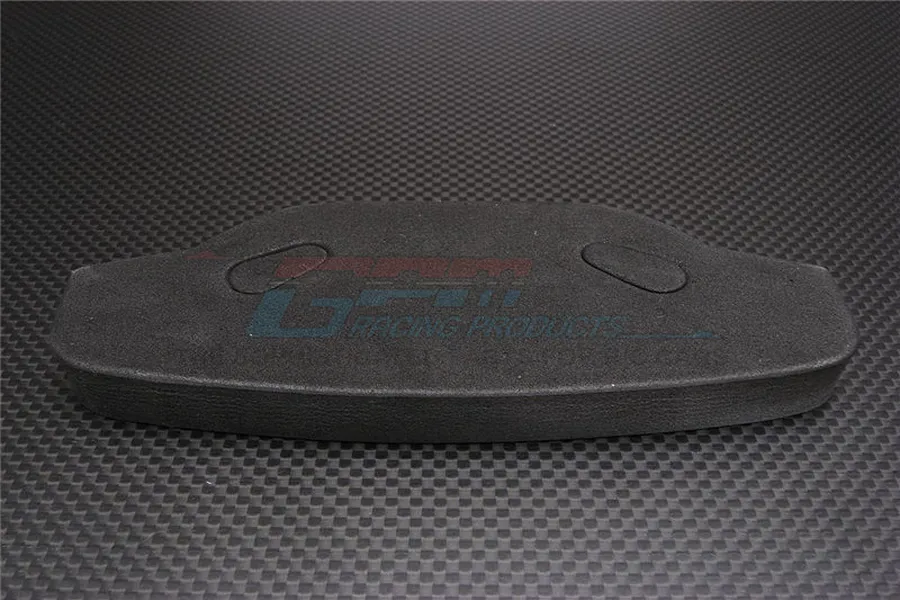 A black urethane foam bumper for an RC car, featuring the GPM Racing logo, set against a carbon fiber textured background.