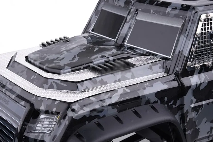 Close-up of a camouflage RC truck body showing the installed black front air intake covers on the hood.