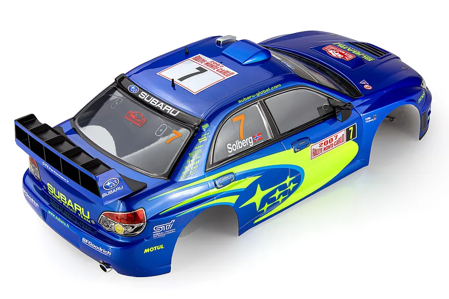 A high-angle studio shot of a pre-painted 1/10 scale Subaru Impreza WRC body shell in blue with yellow decals and racing livery.