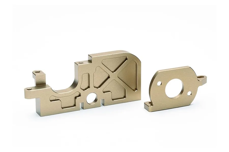 A gold-anodized machined aluminium motor mount set for a Maverick Quantum RC vehicle, shown against a white background.