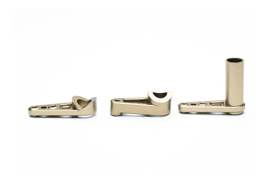 Three gold-coloured aluminium servo saver components arranged on a white background.