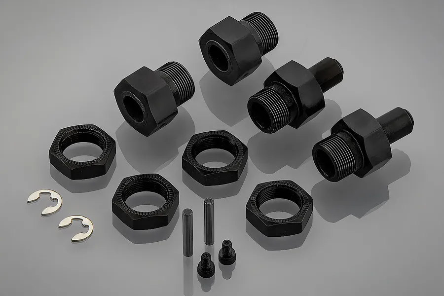 A set of Rovan black aluminium wheel hubs, including nuts, pins, and clips, arranged on a grey reflective surface.