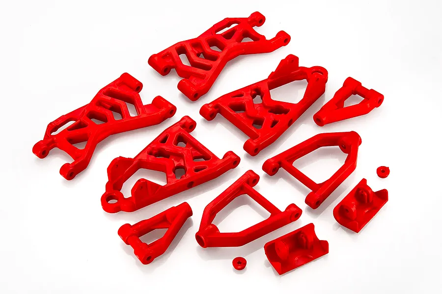 A set of bright red plastic RC suspension arms and related components arranged on a white background.