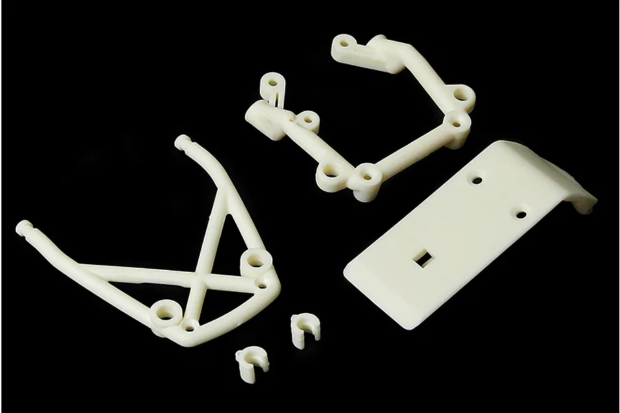 A set of white plastic RC car bumper components including a front bumper plate, two support frames, and two small clips on a black background.