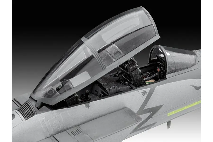 Close-up of the cockpit area of a 1/72 scale F-15E Strike Eagle plastic model kit with the canopy open, showing detailed interior seating and controls.