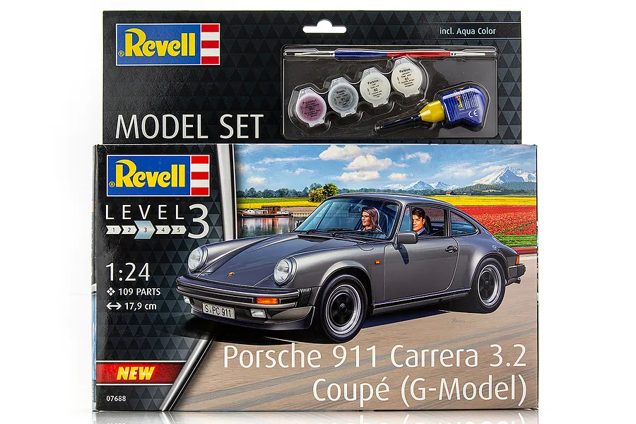 Revell 1/24 scale Porsche 911 Carrera 3.2 Coupé model kit box, featuring a grey car illustration and included paint and glue set.