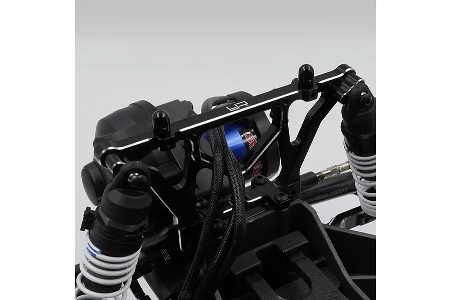A black aluminium Yeah Racing rear shock tower installed on an RC vehicle chassis, featuring silver chamfered edges and the YR logo.