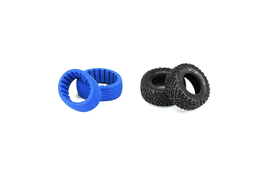 Two black Pro-Line Icon all-terrain RC short course tyres and two blue foam tyre inserts on a white background.