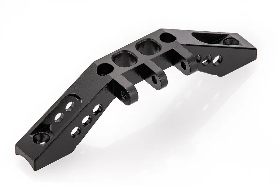 A black anodized aluminium axle truss for an RC car, featuring multiple mounting holes and a rigid, angular design.