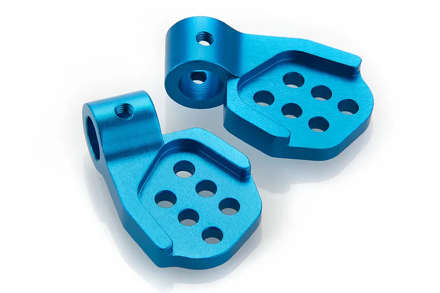 Two blue anodized aluminium rear body post mounts for an RC car, shown from a high angle on a white background.