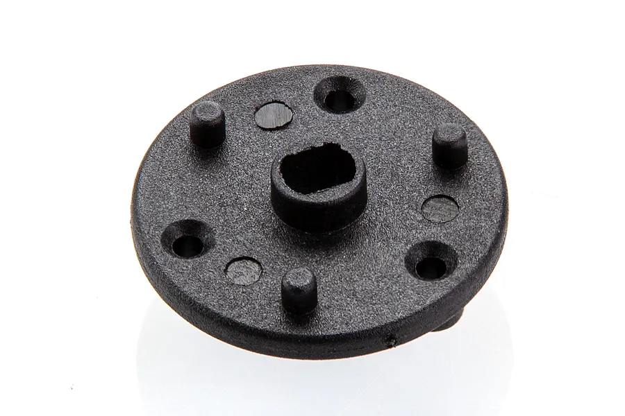 A black plastic RC main gear mount component with a central shaft hole and mounting points on a white background.