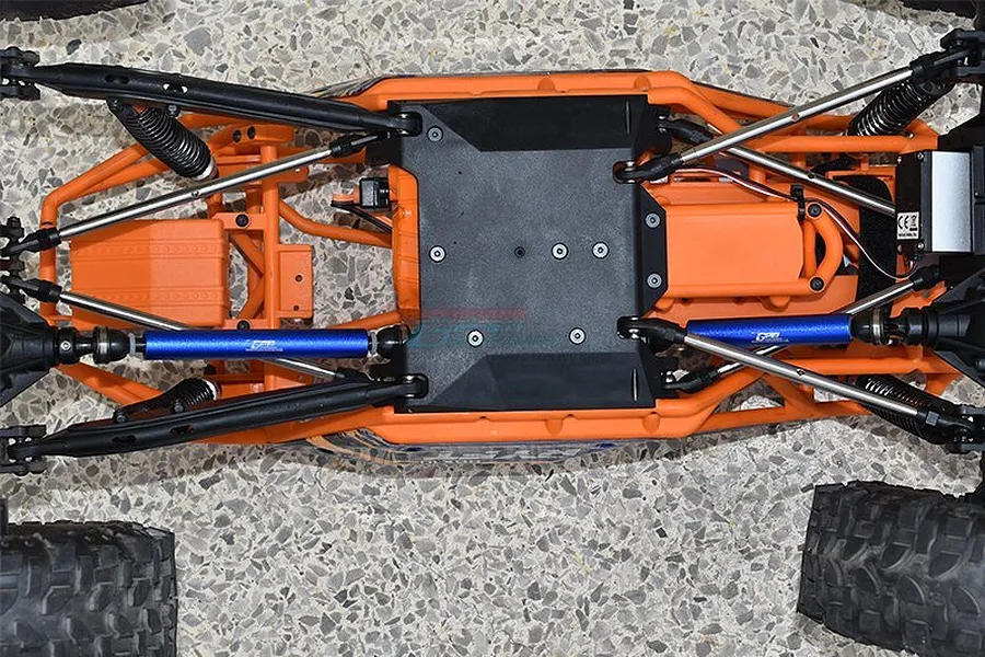 Top-down view of an RC car chassis featuring GPM blue aluminium centre drive shafts installed.