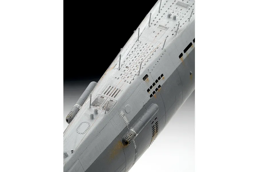 A close-up, high-angle view of a detailed plastic model submarine deck, showing weathered grey paint, rust effects, and fine deck fittings.