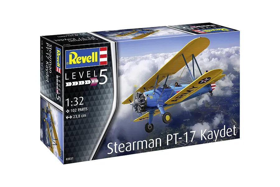 Revell 1/32 scale Stearman PT-17 Kaydet plastic model kit box showing a blue and yellow biplane flying above clouds.
