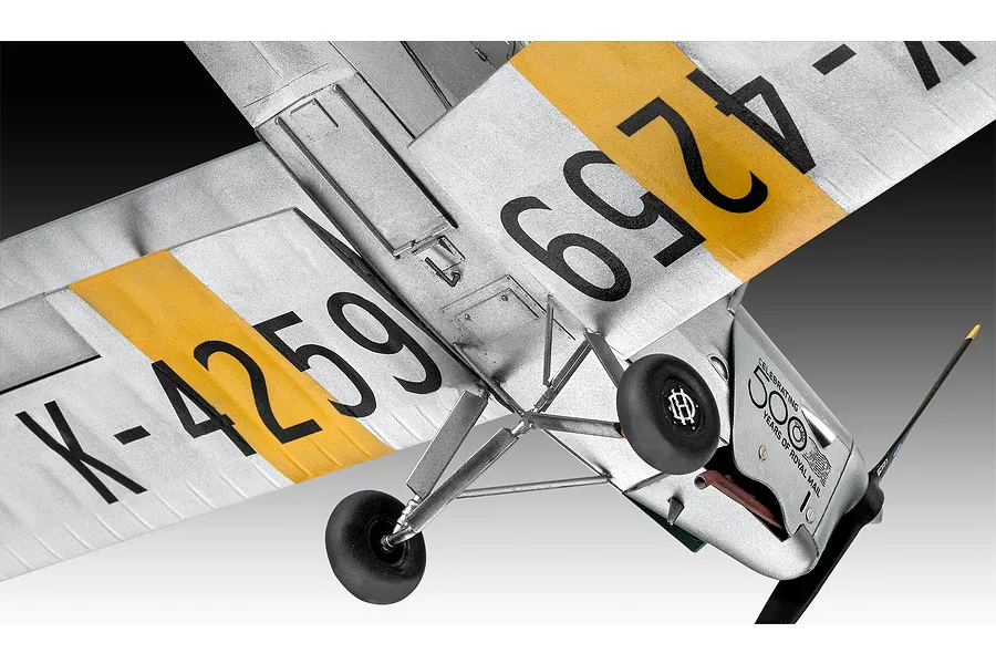 Underside view of a 1/32 scale Revell D.H. 82A Tiger Moth model aircraft showing silver wings with yellow stripes, black markings, and landing gear.