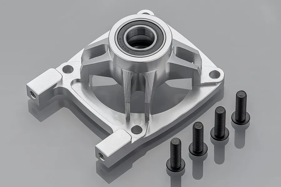 A silver aluminium Rovan clutch bracket for 5IVE-T RC cars, featuring a pre-installed rubber shielded bearing and four black mounting screws.