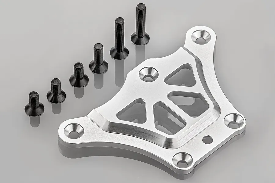 A silver aluminium steering chassis brace for an RC vehicle, accompanied by five black countersunk screws, shown on a grey background.