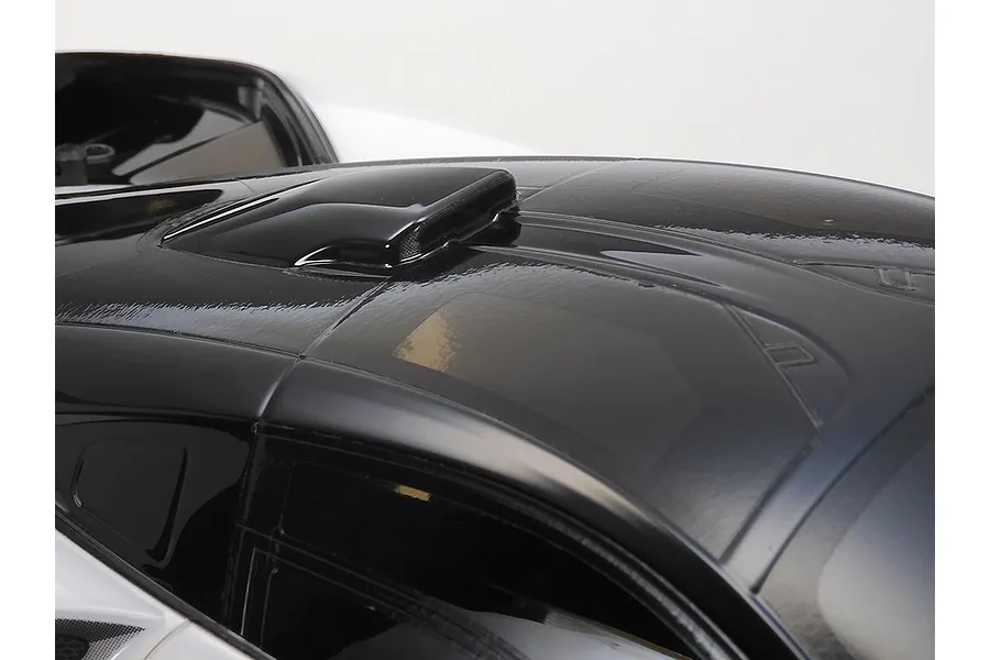 Close-up of the roof and air intake scoop on a black and white McLaren Senna RC car body shell.