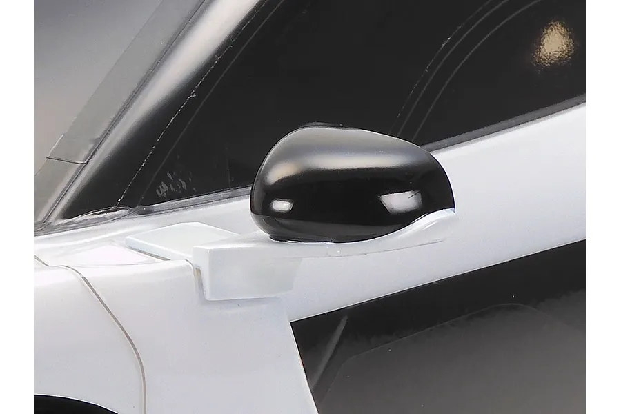 Close-up of the side mirror on a white Tamiya McLaren Senna RC car body.