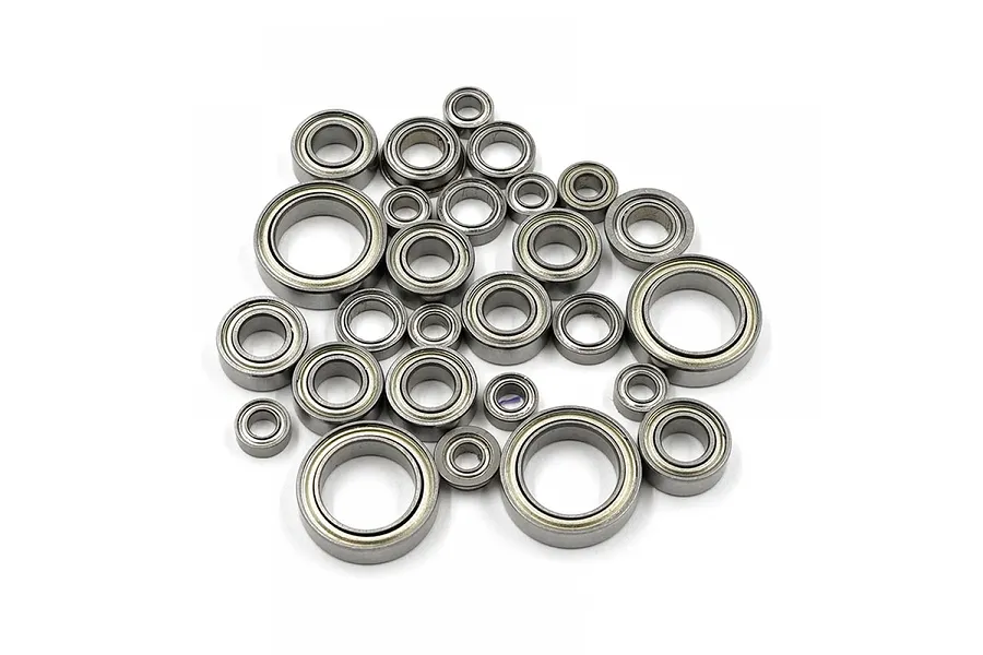 A collection of various sized metal ball bearings for RC cars arranged on a white background.