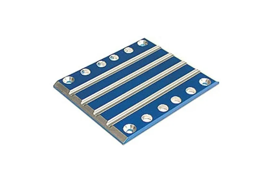 A blue anodized aluminium transmission skid plate for Traxxas RC vehicles, featuring raised silver ribs and countersunk screw holes.