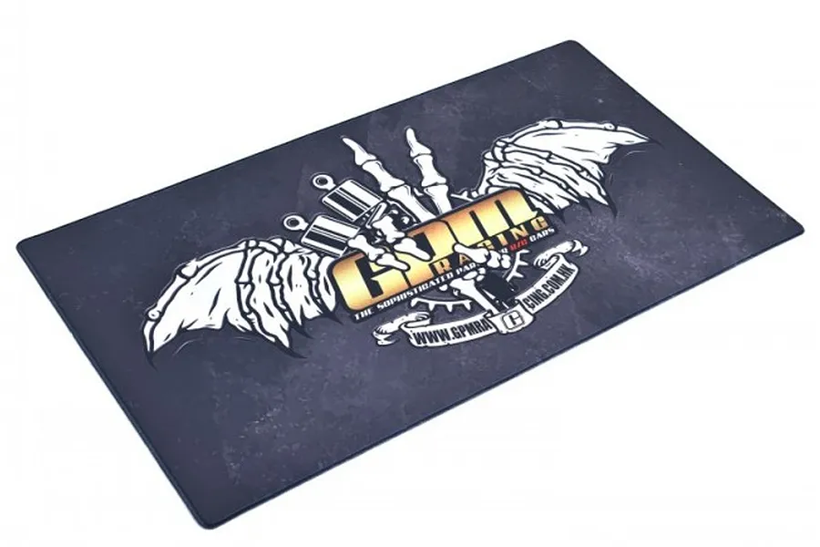 A rectangular GPM Racing pit mat with a dark grey distressed background and a large white skeletal wing logo with gold GPM text.