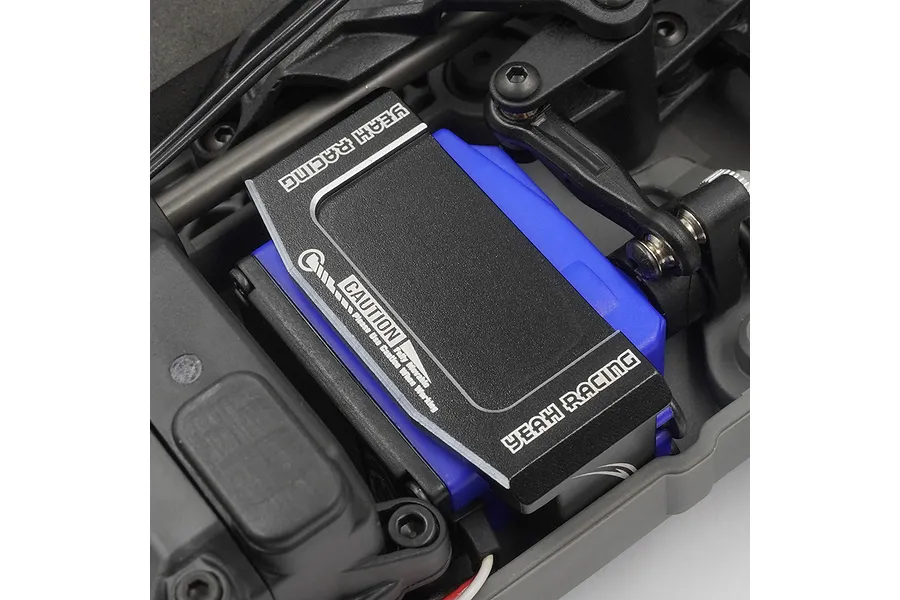 A black aluminium Yeah Racing servo mount installed over a blue RC servo inside a Traxxas 4-Tec chassis.