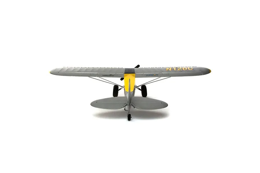 Rear view of the HobbyZone Carbon Cub S2 RC plane showing its grey wings, yellow fuselage, and landing gear against a white background.