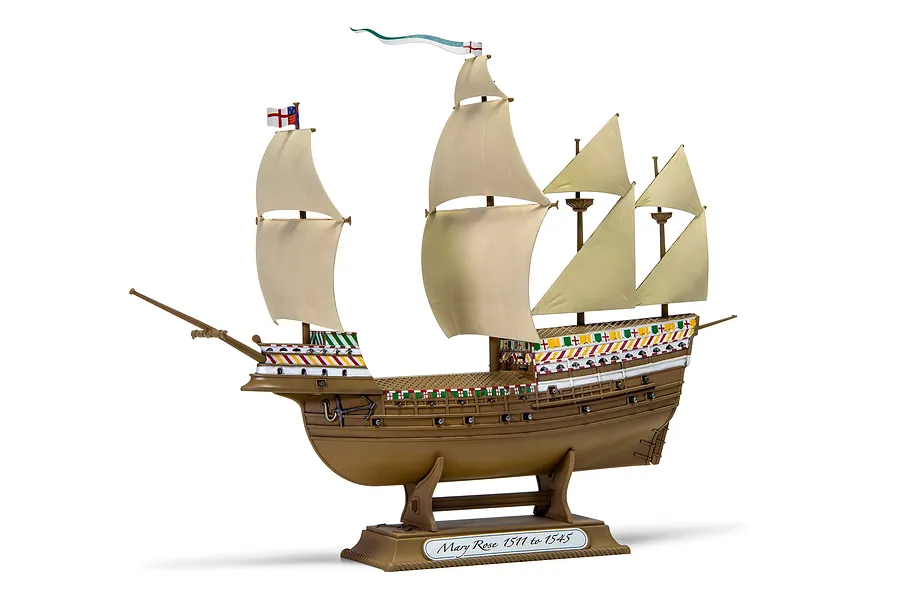 A fully assembled and painted plastic model of the Mary Rose ship, displayed on a brown stand against a white background.