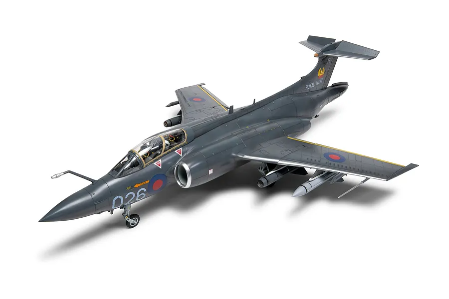 A completed 1/48 scale plastic model of a Royal Navy Blackburn Buccaneer aircraft, painted in dark grey with roundels and markings.