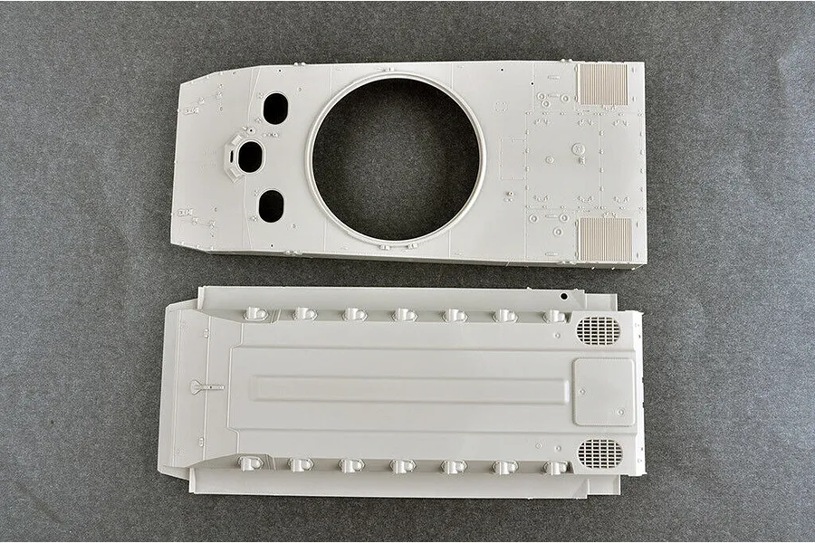 Top-down view of two unpainted grey plastic model tank hull parts from a Trumpeter 1/35 scale kit.