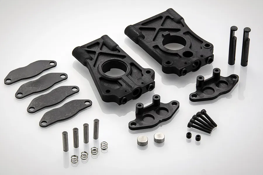Rovan centre differential bracket kit including plastic mounts, metal pins, screws, and springs on a white background.