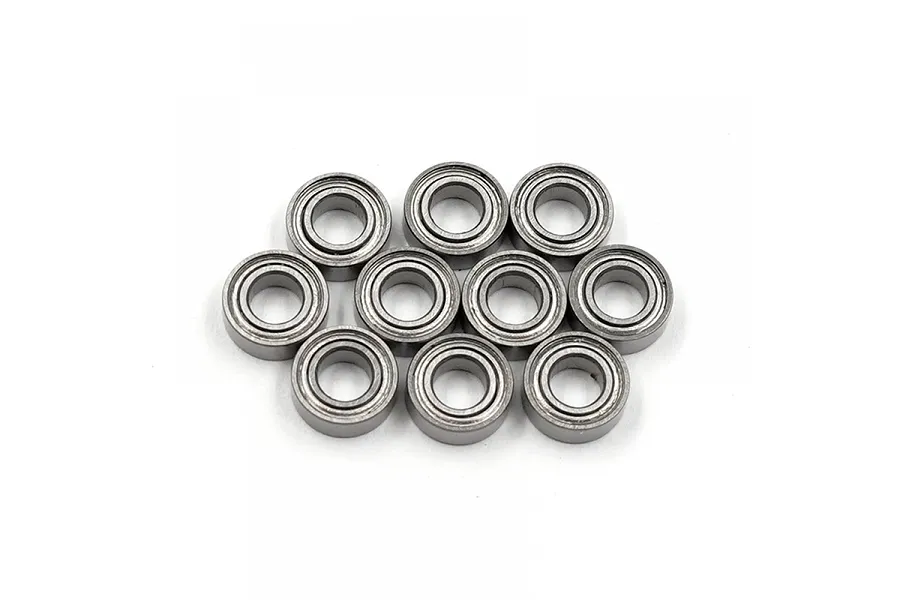 A set of ten small metal shielded ball bearings arranged in a cluster on a white background.