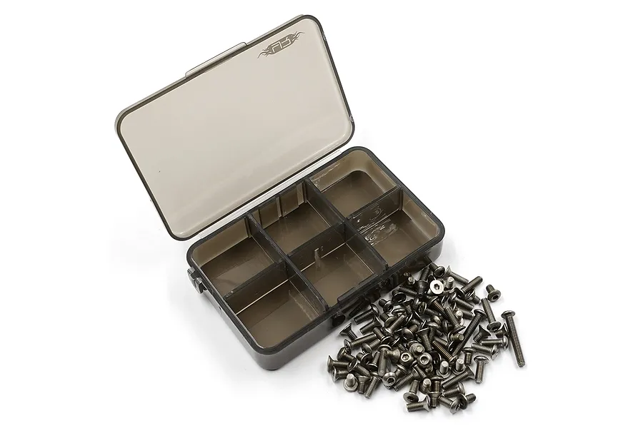 A set of titanium RC screws scattered next to an open, empty six-compartment plastic storage box on a white background.
