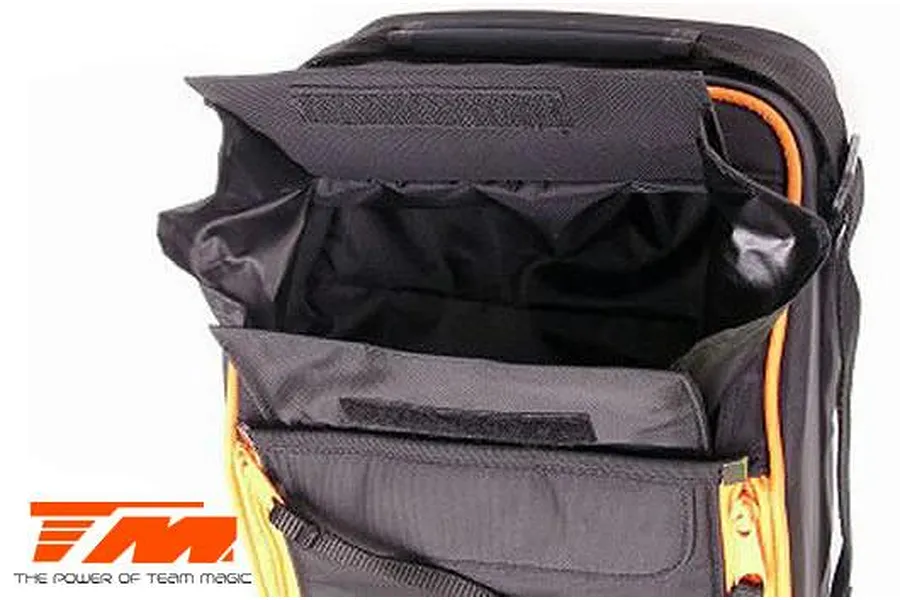 A close-up view of an open black Team Magic transmitter bag with orange trim and a Team Magic logo in the corner.