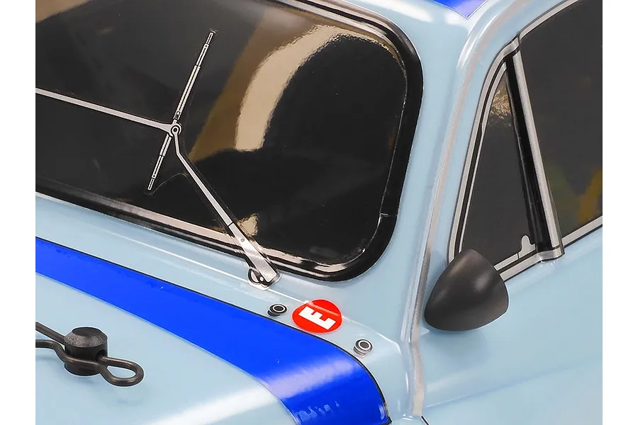 Close-up of the windshield and side mirror of a light blue Tamiya Fiat Abarth 1000TCR RC car body with a blue racing stripe and windshield wiper decal.