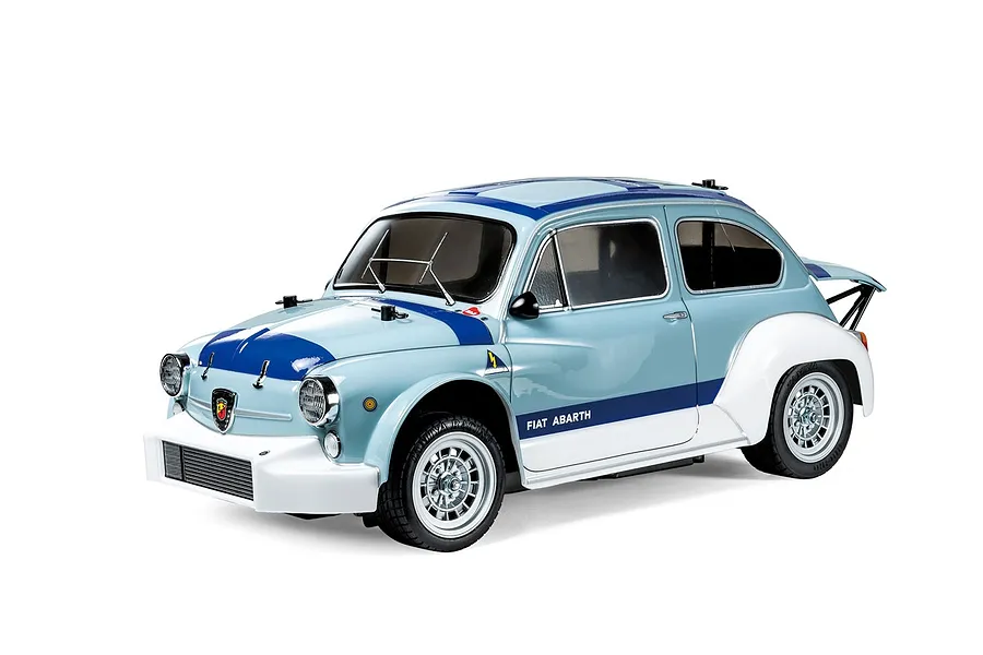 A 1/10 scale Tamiya MB-01 Fiat Abarth 1000TCR RC car kit, featuring a light blue and white body with racing decals, shown on a white background.