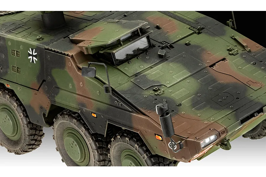 A close-up, high-angle view of a 1/35 scale Revell German GTK Boxer model kit, showing the camouflaged hull, driver's hatch, and side mirrors.