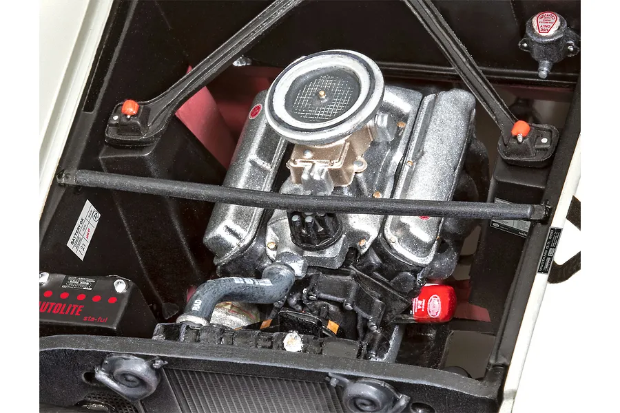 A detailed scale model engine bay of a 1966 Shelby GT 350 R, showing the V8 engine, Autolite battery, and radiator components.