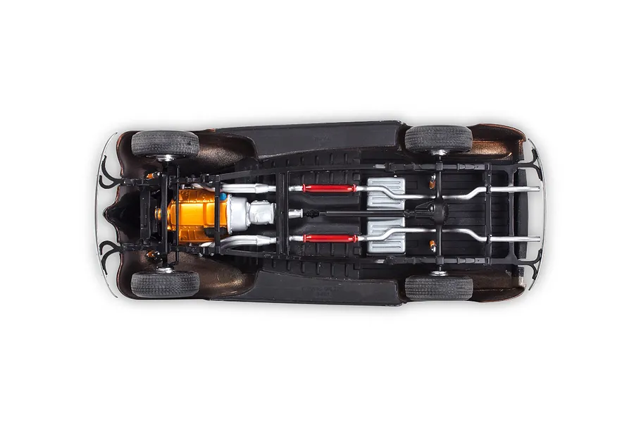 Underside view of a 1/24 scale model car chassis showing the engine, exhaust system, and drivetrain details.