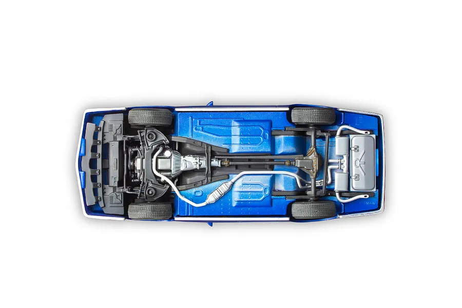 Underside view of a 1/24 scale model 1985 Chevy Camaro Z28 showing the chassis, drivetrain, exhaust system, and wheels.