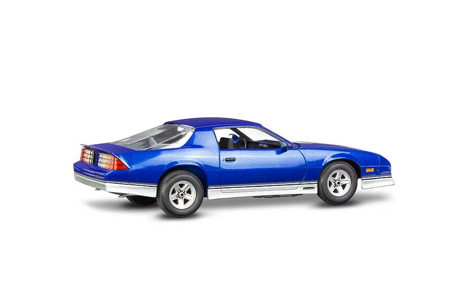 A side-rear view of a blue 1985 Chevy Camaro Z28 scale model car with silver lower body trim, sitting on a white background.