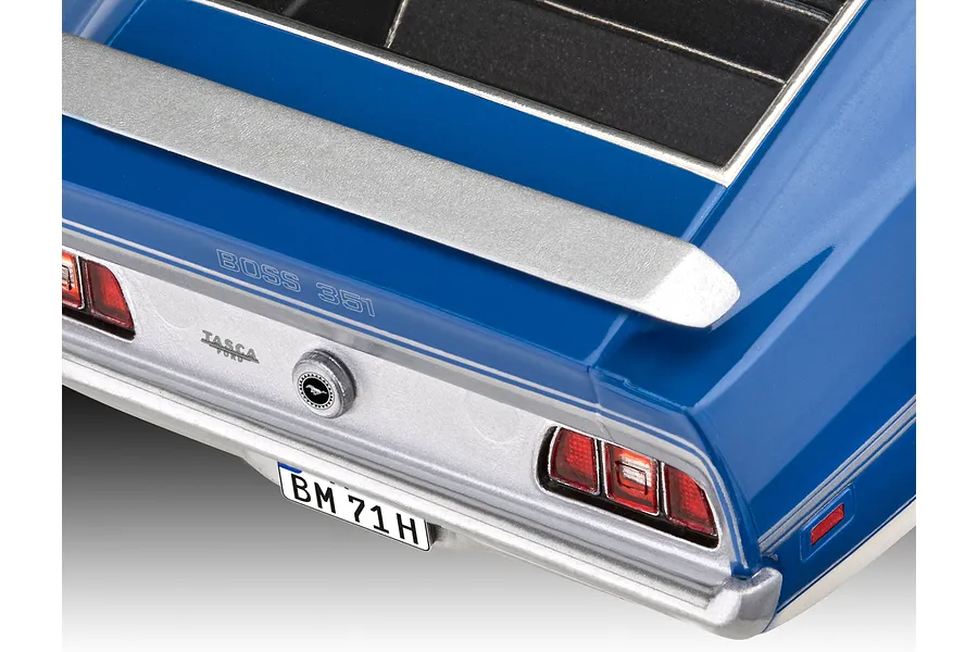Rear view of a blue 1/24 scale 1971 Ford Mustang Boss 351 model car showing the spoiler, taillights, and Tasca Ford badge.