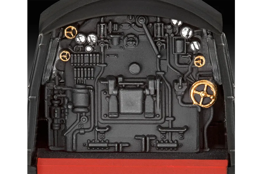 Close-up of the detailed black and gold locomotive cab interior from a Revell 1/87 scale model kit.